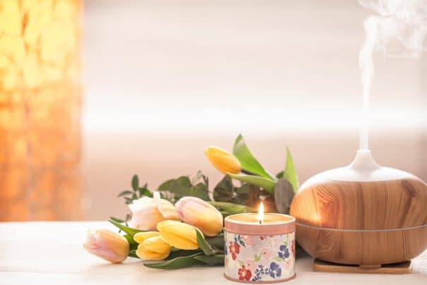 - aromatic oil diffuser lamp table blurred with beautiful spring bouquet tulips burning candles - ภาพที่ 15