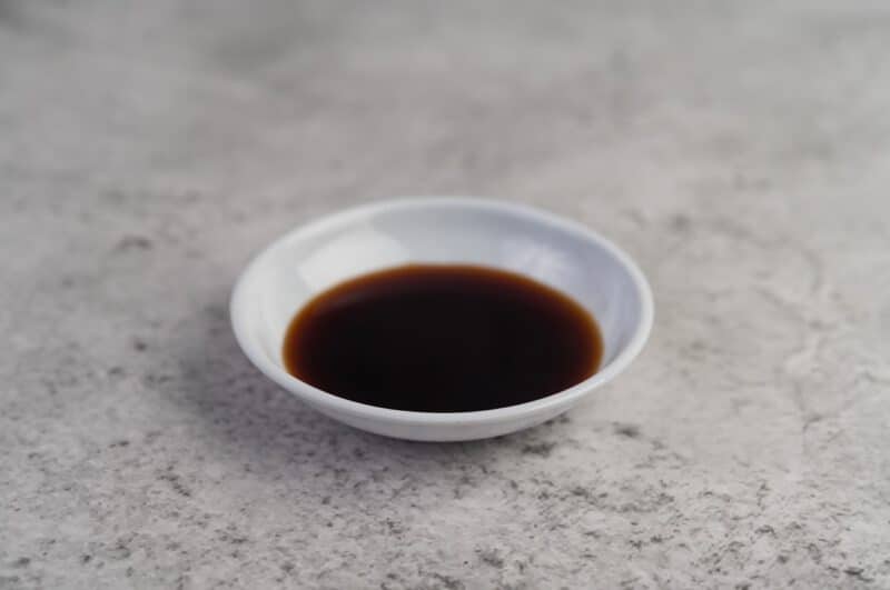 - black sauce small white cup placed cement floor - ภาพที่ 15