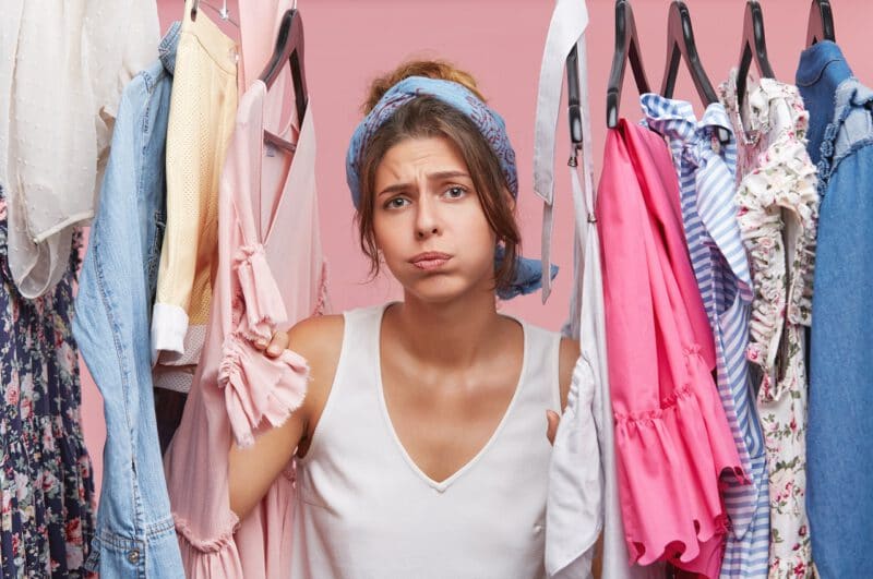 สถานที่รับบริจาคเสื้อผ้า - depressed female standing near wardrobe rack full clothes having difficult choice knowing what put - ภาพที่ 3