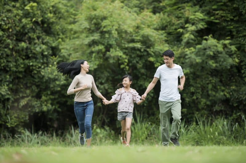 - happy family is having fun mother father daughter are running park - ภาพที่ 9