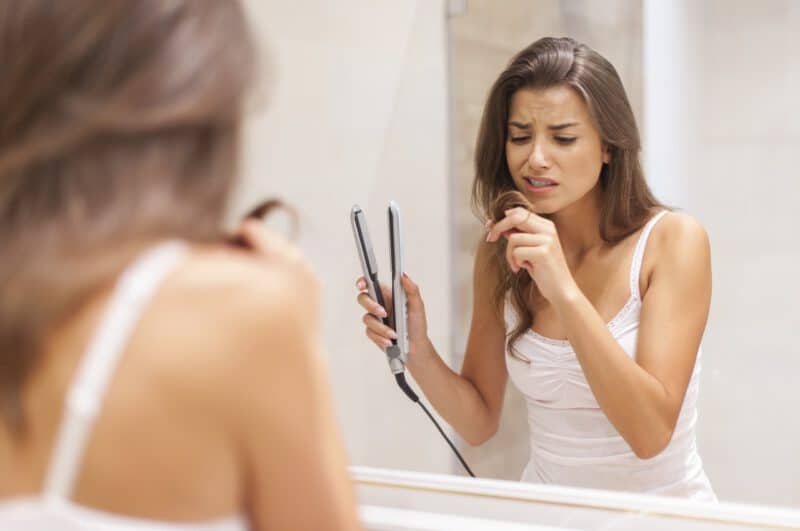 - woman straightening hair bathroom - ภาพที่ 5