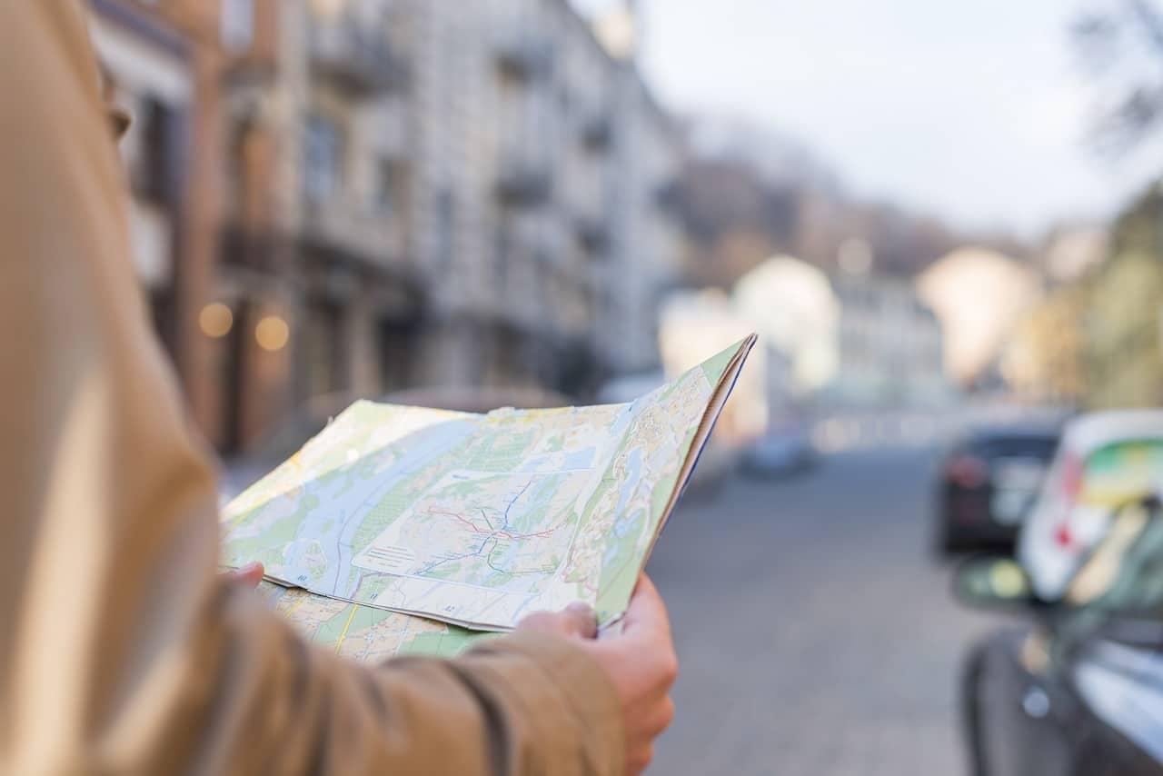 แผนที่ - close up male traveler holding map hand standing city street - ภาพที่ 5