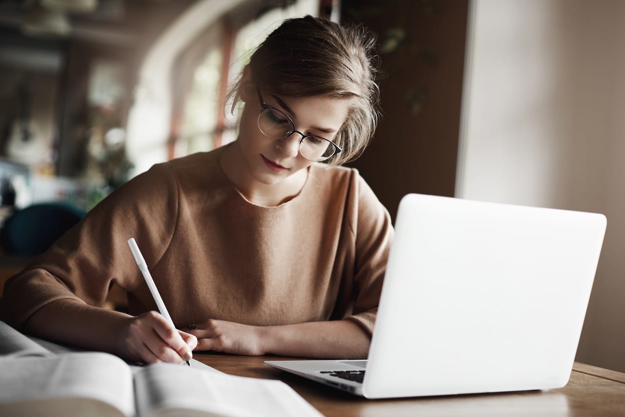 เขียนนิยาย - hardworking focused woman trendy glasses concentrating writing essay sitting cozy cafe near laptop working making notes carefully - ภาพที่ 5