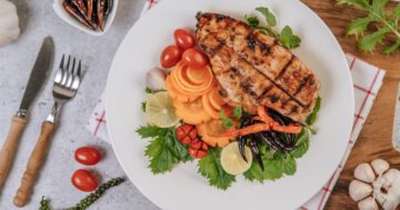 chicken steak with lemon tomato chili carrot white plate Large