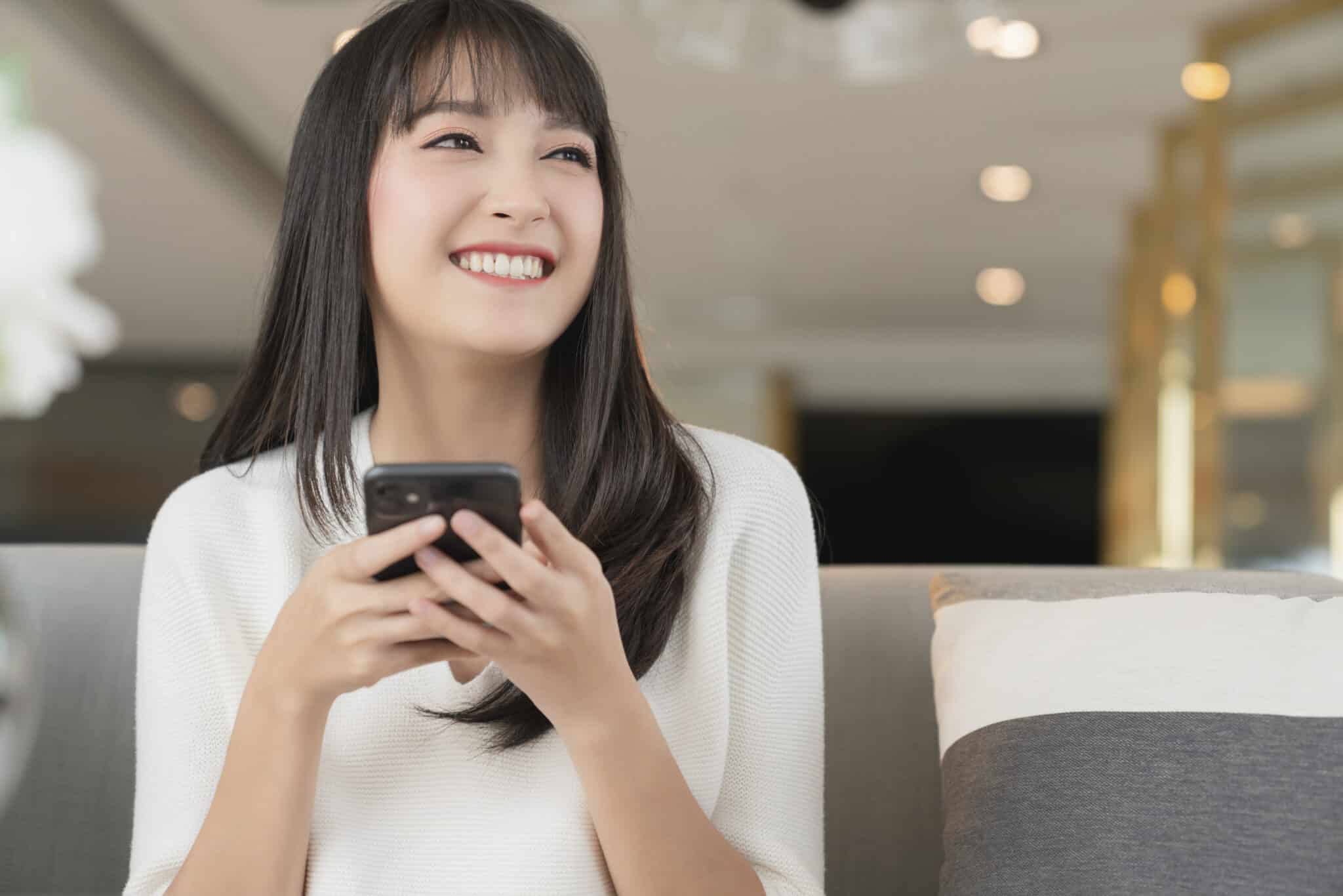 แคปชั่นตลก - smile happiness cheerful asian female hand use smartphone think look out with joyful smartphone technology communication ideas concept home background scaled - ภาพที่ 5