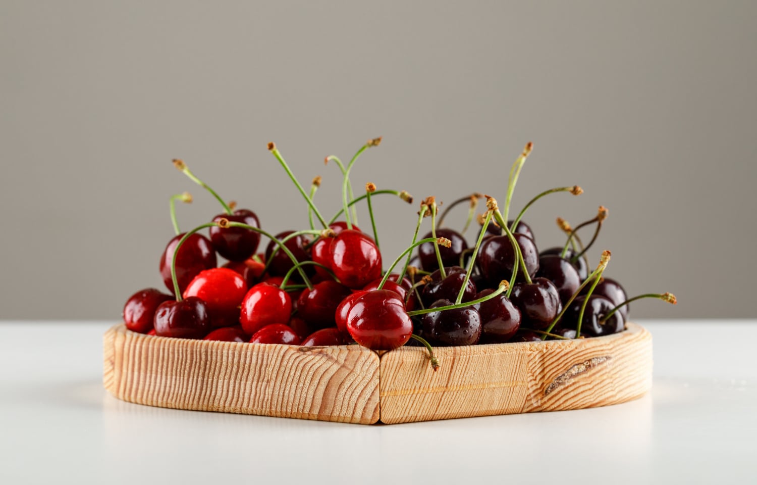 - sweet cherries wooden plate white grey surface side view - ภาพที่ 11