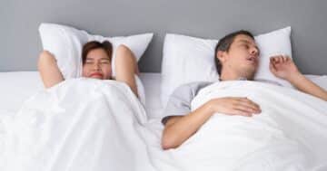 angry asian woman annoyed with husbands snoring Large