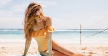ถ่ายรูปชุดว่ายน้ำ - pensive woman yellow sunglasses posing sandy beach looking down carefree slim girl vintage swiwear lying ground ocean shore Large - ภาพที่ 1